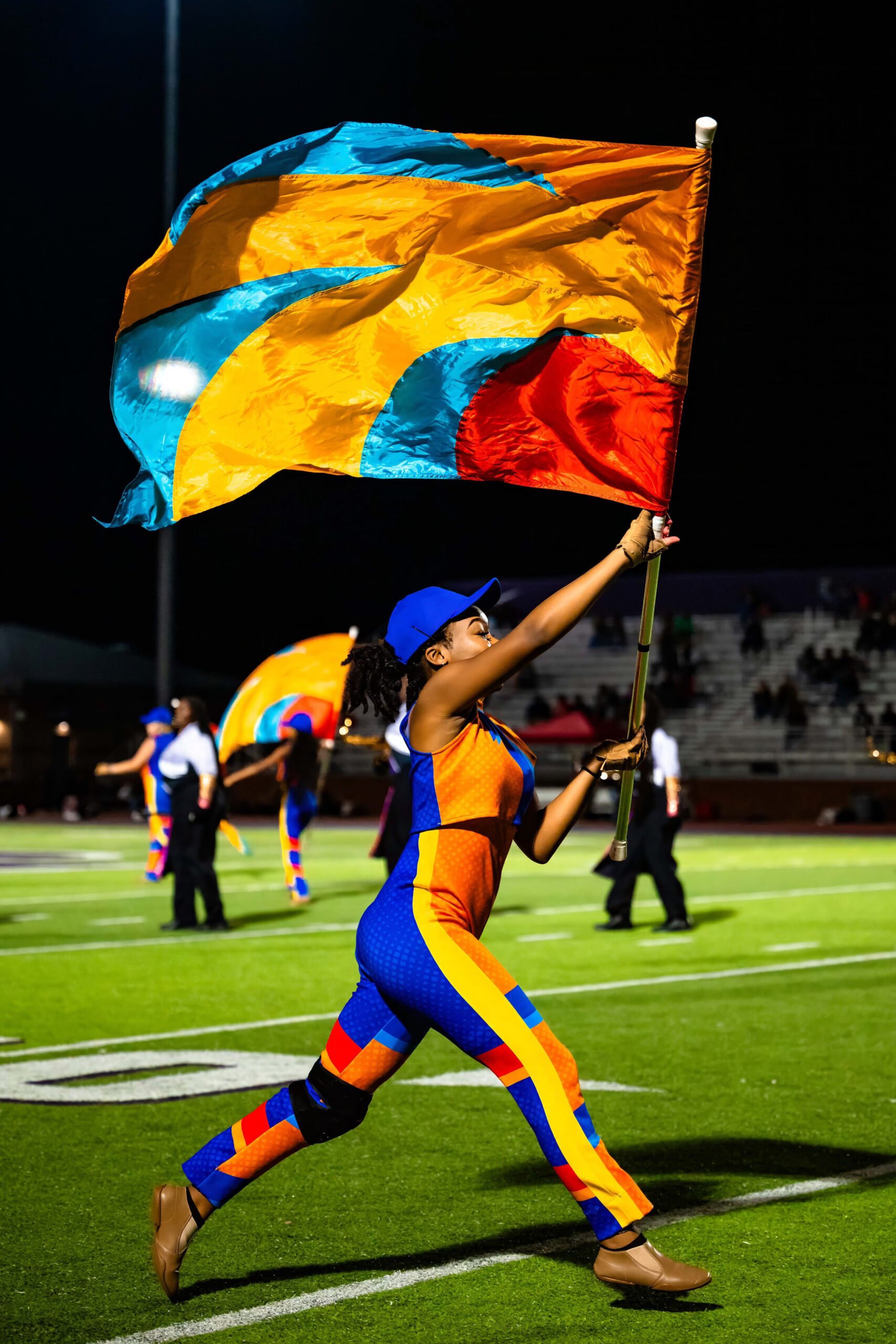 Color guard captain runs while raising flag